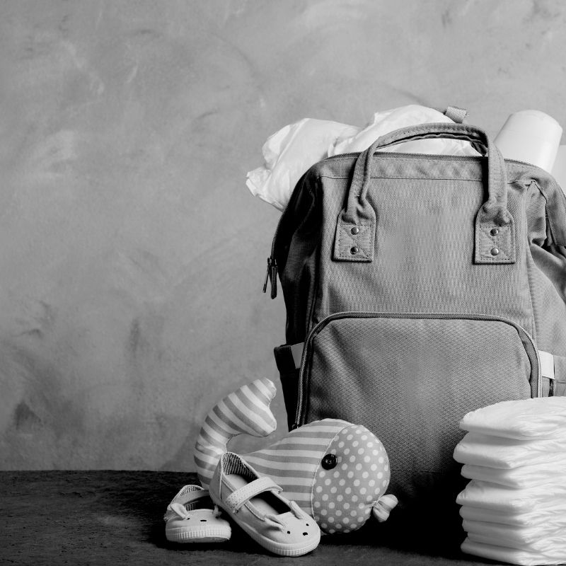 Stacks of baby diapers and a diaper bag