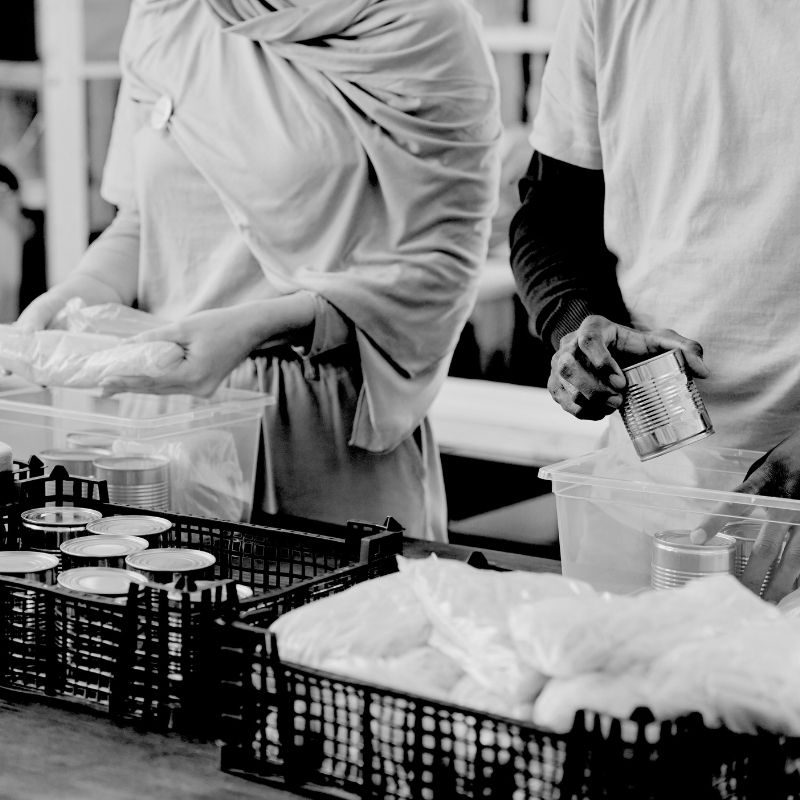 Two women are sorting donations on a table